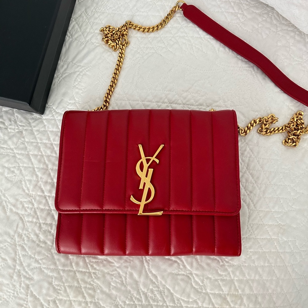 Yves Saint Laurent Red Vicky wallet on a chain with large gold YSL logo.